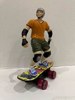 Front view of Tony Hawk figure on skateboard