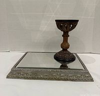 Mirror tray lying flat with candle holder on top