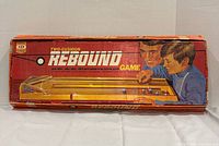 Box lid showing Ideal Rebound Two-Cushion Action Game graphics