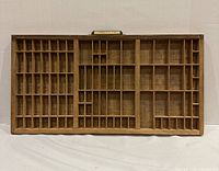 Front view of full wooden printers type drawer showing compartment layout