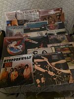Stack of thirteen classic rock LPs in sleeves