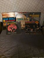 All six album covers fanned out on table