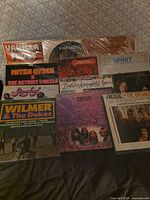 Group shot of all ten LP record covers laid out on surface