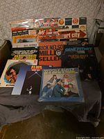 Box of assorted LP records showing front covers
