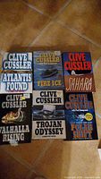 All six Clive Cussler books laid out face up
