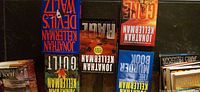 Five Kellerman novels laid flat plus additional stacked books