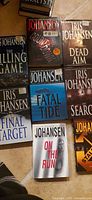 Group of seven Iris Johansen novels laid out