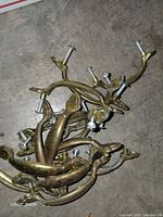 Pile of brass drawer pulls showing design and attached bolts