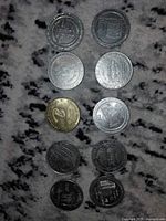 Front faces of ten gaming tokens showing design variety