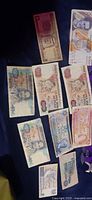 Group of assorted foreign banknotes spread on dark cloth