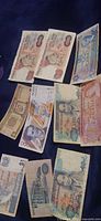 Overview showing four UK 10-Shilling notes, Canada $5, Chile 5000-Pesos, unidentified brown note, Indonesia 1000-Rupiah, Canada $2, two Singapore $1 notes