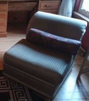Front three-quarter view of lounge chair with bolster pillow