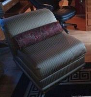 Full view of striped armless lounge chair