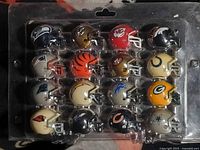 Front view showing first 16 NFL mini helmets in plastic tray
