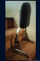 Side view showing chrome bracket and padded backrest