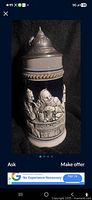 Front view of stoneware stein showing tavern scene and pewter lid