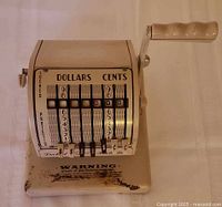 Front view showing numeric dials, handle, rust on base