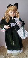 Doll removed from box standing upright showing full attire