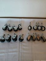 Sixteen casters arranged in four rows of four illustrating all sets together