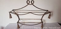 full view of two-tier gilt iron wall shelf showing rope motif and tassels