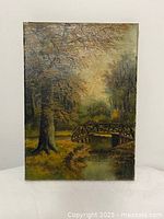 Front view of vertical oil painting showing forest scene with bridge over stream