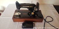 Singer sewing machine on wood base with foot pedal