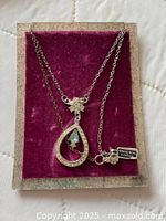 Necklace on display card showing pendant, star charm and RHODIUM FINISH tag