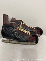 Left side view of both skates showing leather uppers, laces and blades