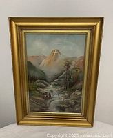 Front view showing full framed painting with mountain, river and cross