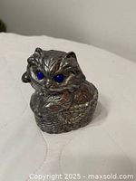 Front view showing cat in basket, blue eyes, textural detail