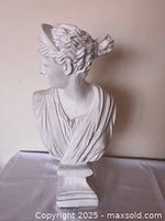 Front left view of white plaster bust on pedestal