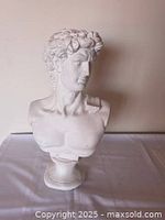 Front view of white plaster bust of David on pedestal base