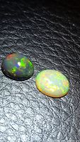 Black and white opal cabochons on textured background