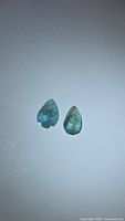 Two leaf-shaped Paraiba blue tourmalines side by side