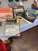 All four repair manuals displayed with covers visible