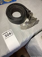 Belt coiled with silver-tone lighter buckle