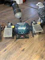 Front view of Mastercraft bench grinder showing both wheels, tool rests, eye shields and lamp