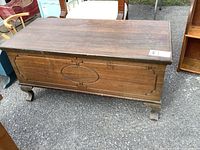 Front view of cedar lined chest showing decorative panel and feet
