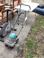 Full view of Yardworks electric tiller with handle, wheels and motor housing