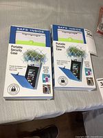 Both boxed Safe Inside portable security cases on table