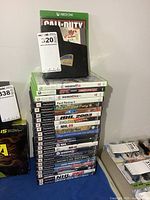 Full stack of Xbox, PS2 game cases showing spines