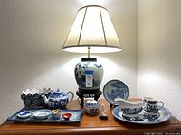 Full view of lamp and porcelain pieces on dresser
