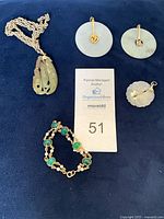 All jewellery pieces laid out on blue background