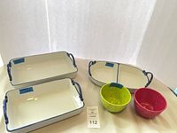 Two rectangular dishes, one oval divided dish, two small speckled bowls