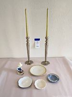 Full lot: two tall candlesticks with tapers, figurine, four dishes