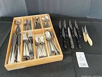 Top view of entire lot showing tray filled with flatware and separate steak/utility knives