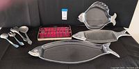 Entire lot showing three fish trays, four utensils, Kalmar box with cocktail picks