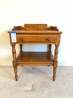 Front view of solid wood side table with drawer and shelf