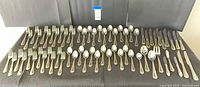 Full layout of 48-piece flatware set with serving pieces displayed