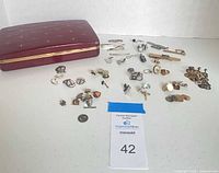 Overview of all jewellery pieces spread out with burgundy storage case